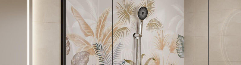 Chrome handheld shower with round head, hose and wall mount on neutral tiles