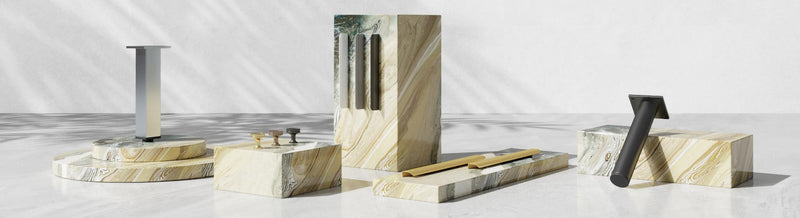 Modern vanity accessories and parts displayed on marble plinths
