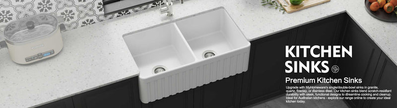 Double bowl white farmhouse kitchen sink in modern kitchen.