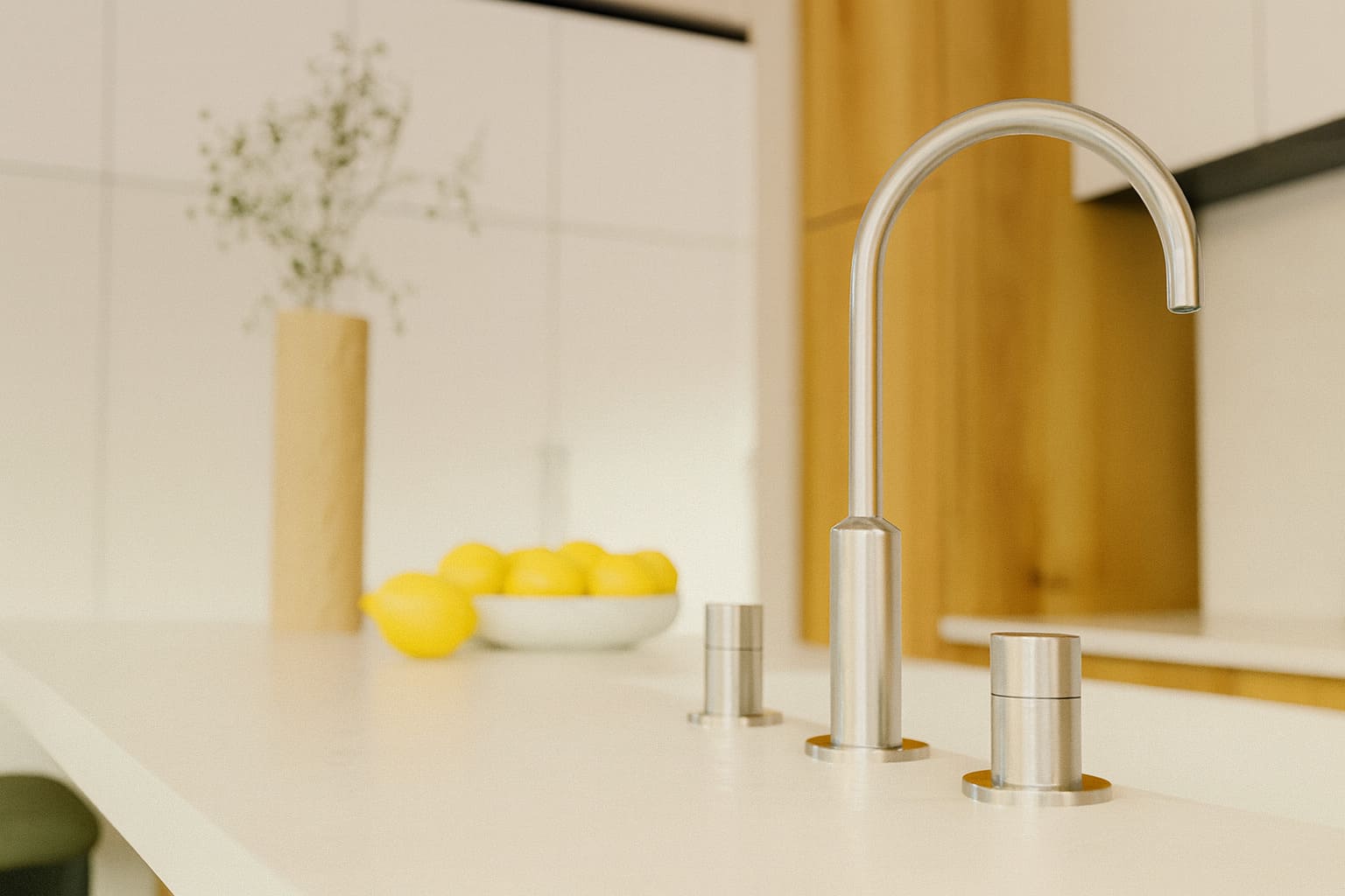 Modern kitchen with a stainless steel gooseneck tap and minimalist white benchtop.