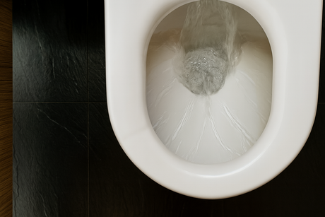 Toilet flushing water swirling inside bowl