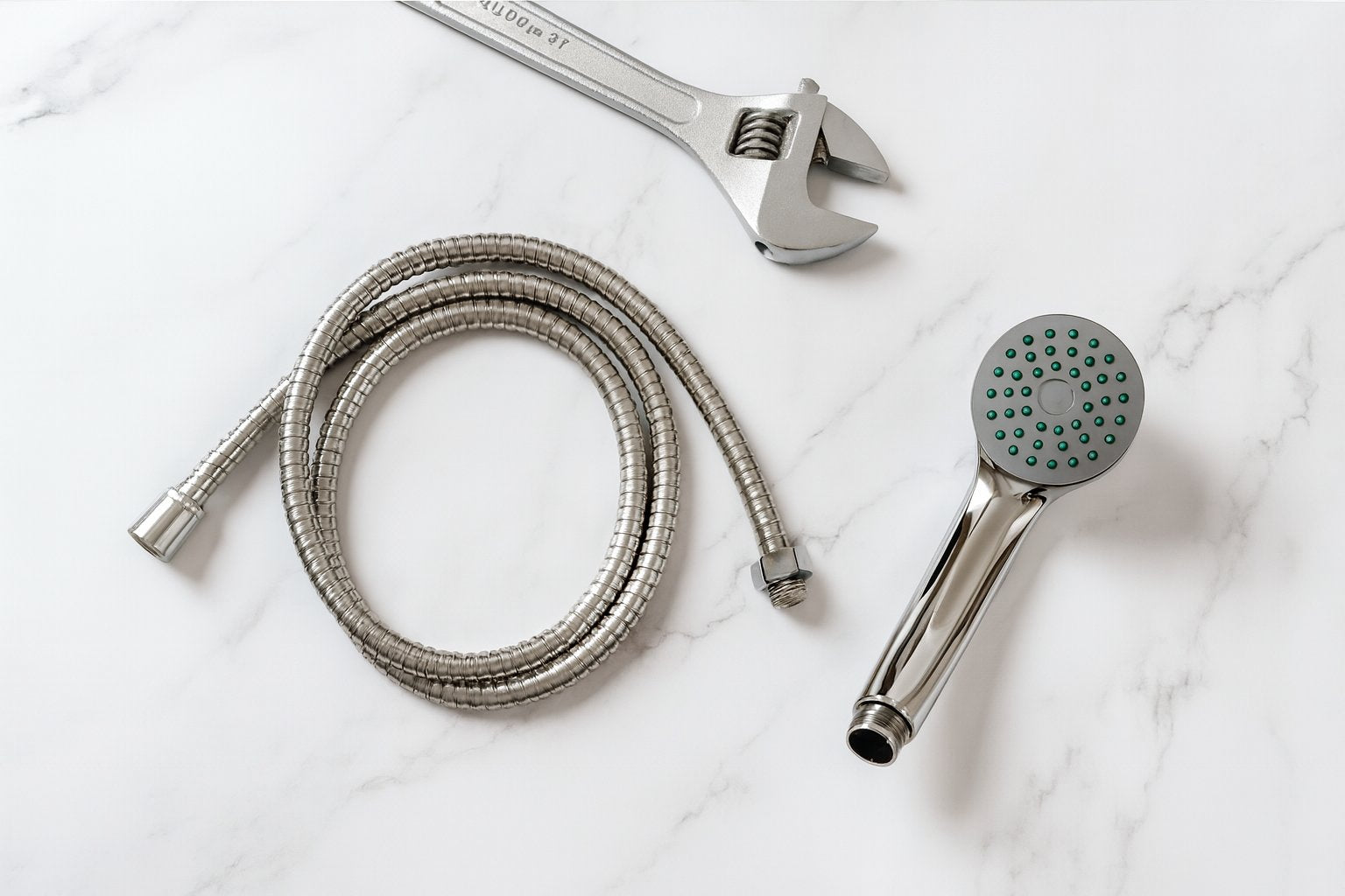 Shower head and hose with wrench on marble surface