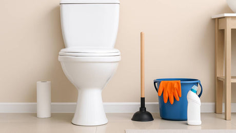 Toilet with plunger and cleaning supplies in a bathroom