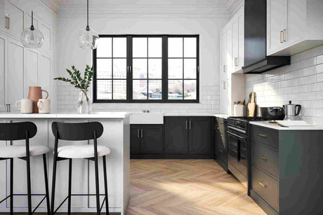 Modern kitchen with white island, dark cabinetry, black-framed window, and herringbone timber flooring.