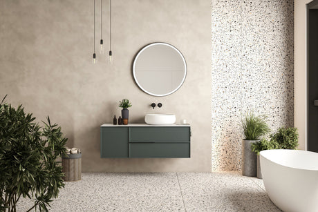 Green and slight blue feature with free standing bathtub and circle mirror with feature wall and plants.