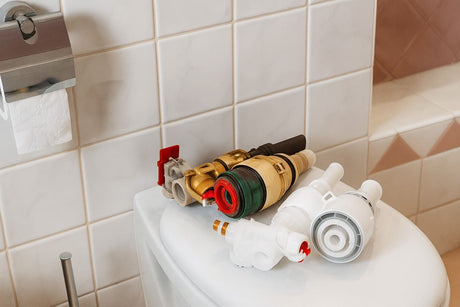 Toilet tank components and parts placed on the toilet seat