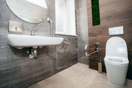 Ambulant toilet with wall-mounted grab rail in modern accessible bathroom