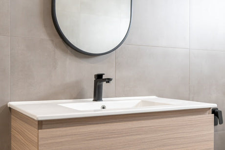 Floating timber vanity with white basin, matte black tap and oval mirror