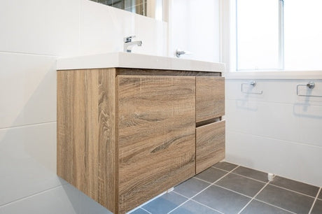 Wall-hung timber bathroom vanity with white basin, chrome tap and grey floor tiles