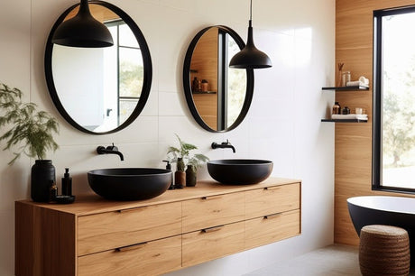 Floating timber vanity with twin black vessel basins, round mirrors and pendant lights