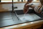 Using drain snake tool to clear clogged kitchen sink with standing water.