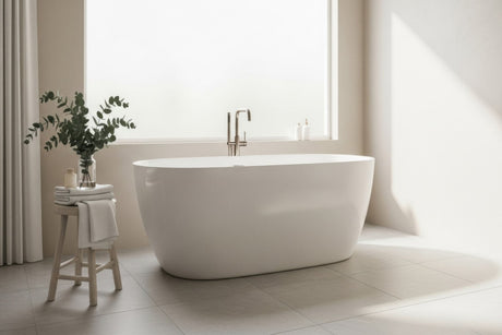 Modern freestanding oval bathtub in a bright minimalist bathroom with natural light
