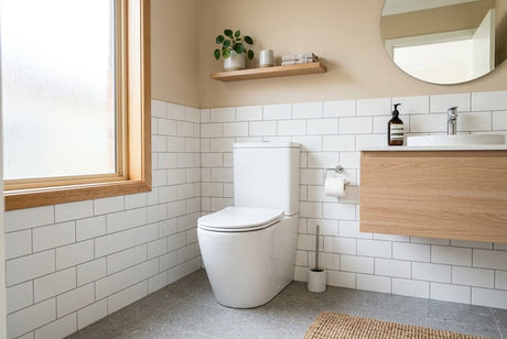 Modern bathroom with white toilet, subway tiles, timber vanity and frosted window