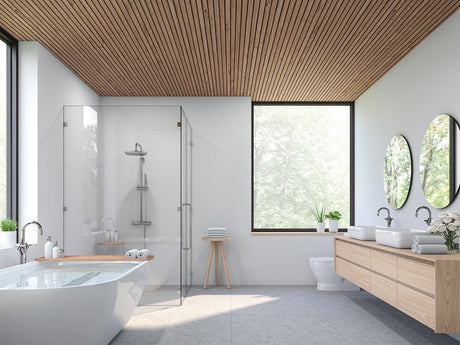 Modern bathroom with wood ceiling, freestanding tub, glass shower, and double vanity.