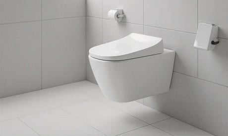 White wall-hung toilet with slim seat against large grey tiles