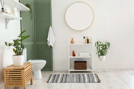 Modern bathroom interior with white toilet, indoor houseplants, wooden shelving and natural light