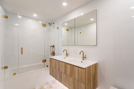 Modern white bathroom interior with floating timber vanity, double basin and brass fixtures