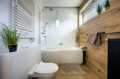 Modern bathroom with white tiles, wood accent wall and contemporary fittings