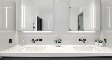 Modern double vanity with twin undermount basins, white benchtop, and illuminated mirrors