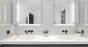 Modern double vanity with twin undermount basins, white benchtop, and illuminated mirrors
