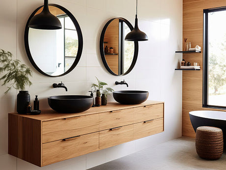  Modern ensuite bathroom with wall-mounted timber vanity, black vessel basins, and large circular mirrors