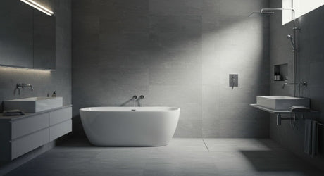 Modern minimalist bathroom interior with grey tiles, freestanding bathtub, and sleek fixtures