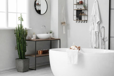 Modern minimalist bathroom with freestanding bathtub, vessel basin vanity, chrome tapware and natural light.