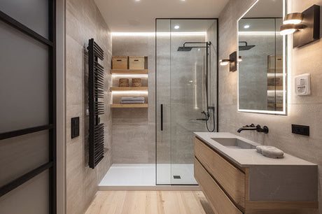 Modern renovated small bathroom with glass shower enclosure, wall-hung timber vanity and black tapware