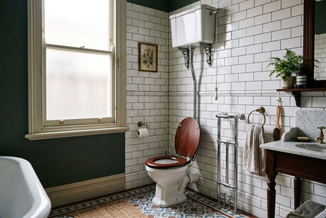 Victorian-style bathroom with high-cistern toilet, white subway tiles and patterned floor