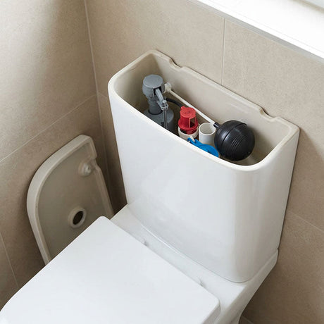 Open toilet cistern revealing fill valve, flush valve, float ball and internal components