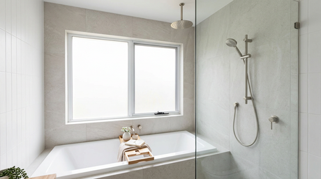 Modern bathroom with built-in bath, glass shower screen, ceiling rain head and brushed nickel tapware