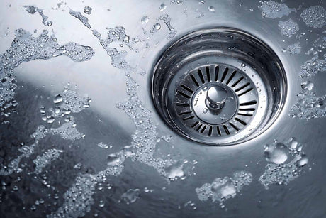 Sink plug stuck in drain opening inside stainless steel basin