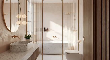 Modern bathroom with terrazzo basin, built-in bath, gold taps and round mirror