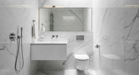 Modern white marble bathroom with wall-hung toilet, floating vanity and chrome tapware