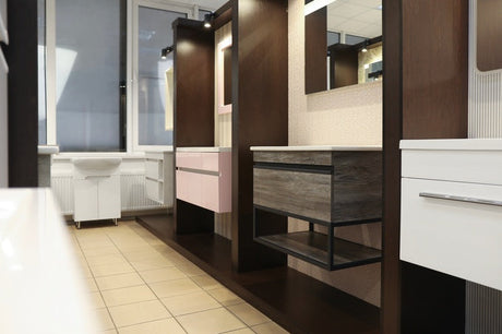 Bathroom showroom displaying multiple vanity styles in pink, timber, and white