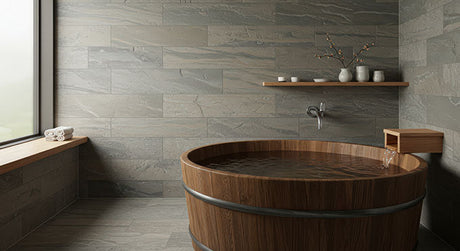 Traditional wooden ofuro soaking tub in a wabi-sabi inspired stone bathroom