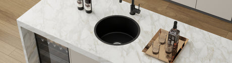 round black single bowl kitchen sink with black tap
