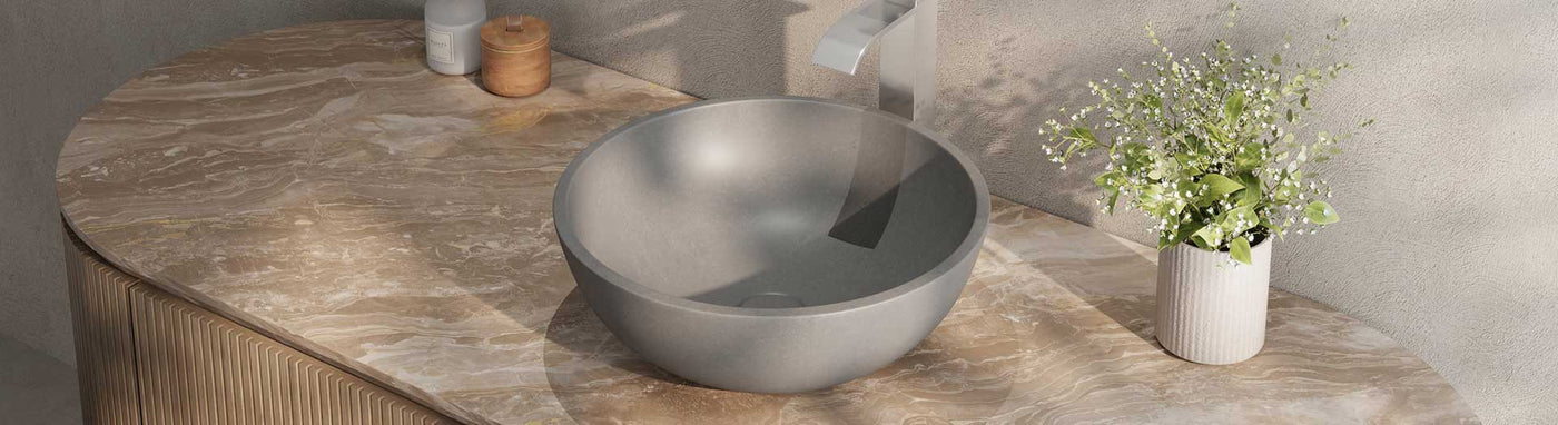 Round solid surface basin on marble vanity top