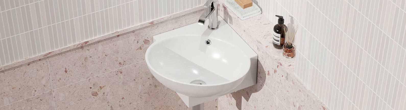 Wall-mounted white ceramic corner basin installed in a compact bathroom