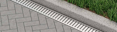 Outdoor linear drain with pavers and grass