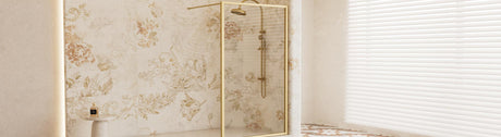 Fixed glass shower panel with brushed gold frame.