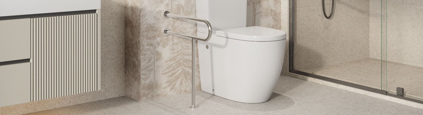 Stainless L-shaped grab rail positioned beside a modern toilet and vanity.