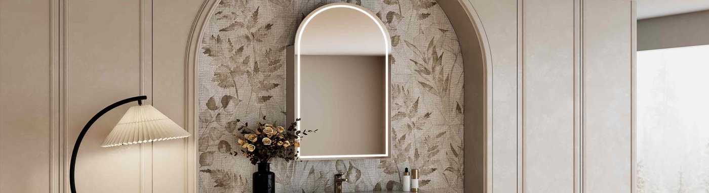Arched LED shaving cabinet mounted in a recessed floral wall niche with soft ambient lighting