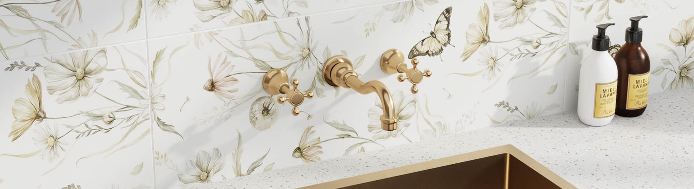 Elegant wall-mounted 3-piece tap sets with metallic finishes showcased on marble plinths.