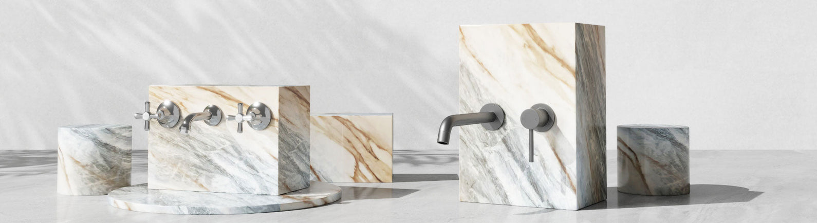 Assorted commercial laundry taps and fittings arranged on textured marble blocks.