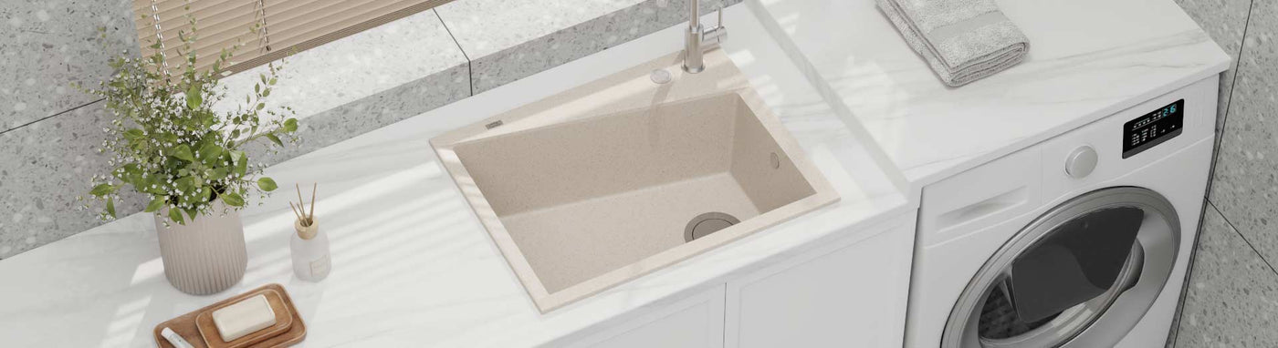 Beige granite laundry sink with matching tap on a white benchtop