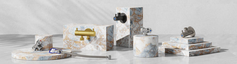 Various laundry tap accessories, including hoses and fittings, displayed on marble surfaces.