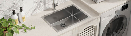 Modern stainless steel laundry sink with sleek design in a bright laundry space