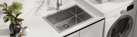 Top mount stainless steel laundry sink with modern chrome tap and marble splashback