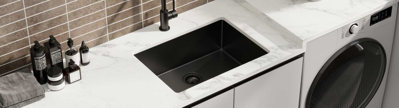 Modern undermount black laundry sink with matte black tap and marble benchtop